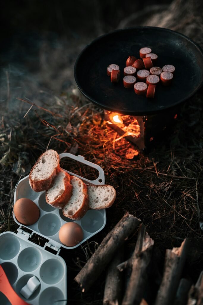 a grill with eggs and sausages next to it a grill with eggs and sausages next to it
